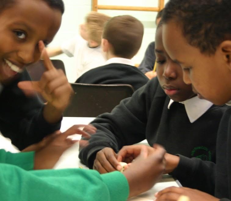 Children working together on number-card activities